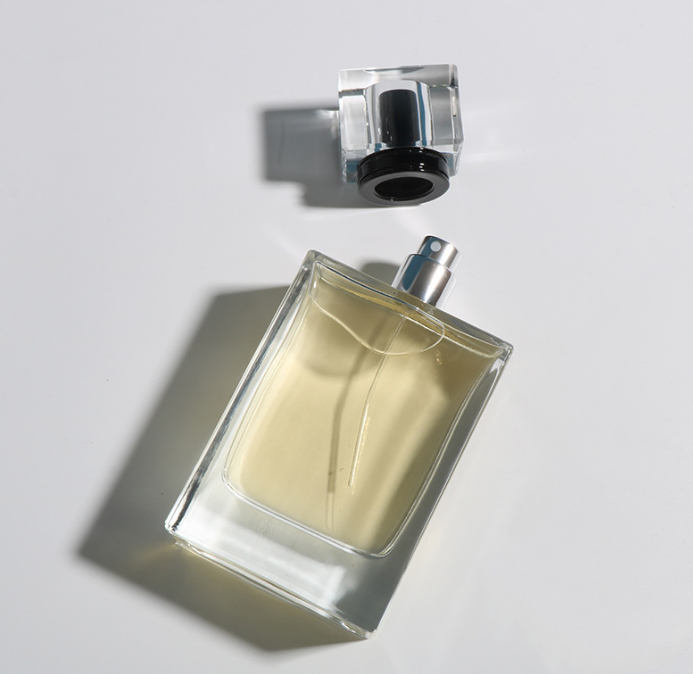 A perfume bottle with light brown liquid on it
