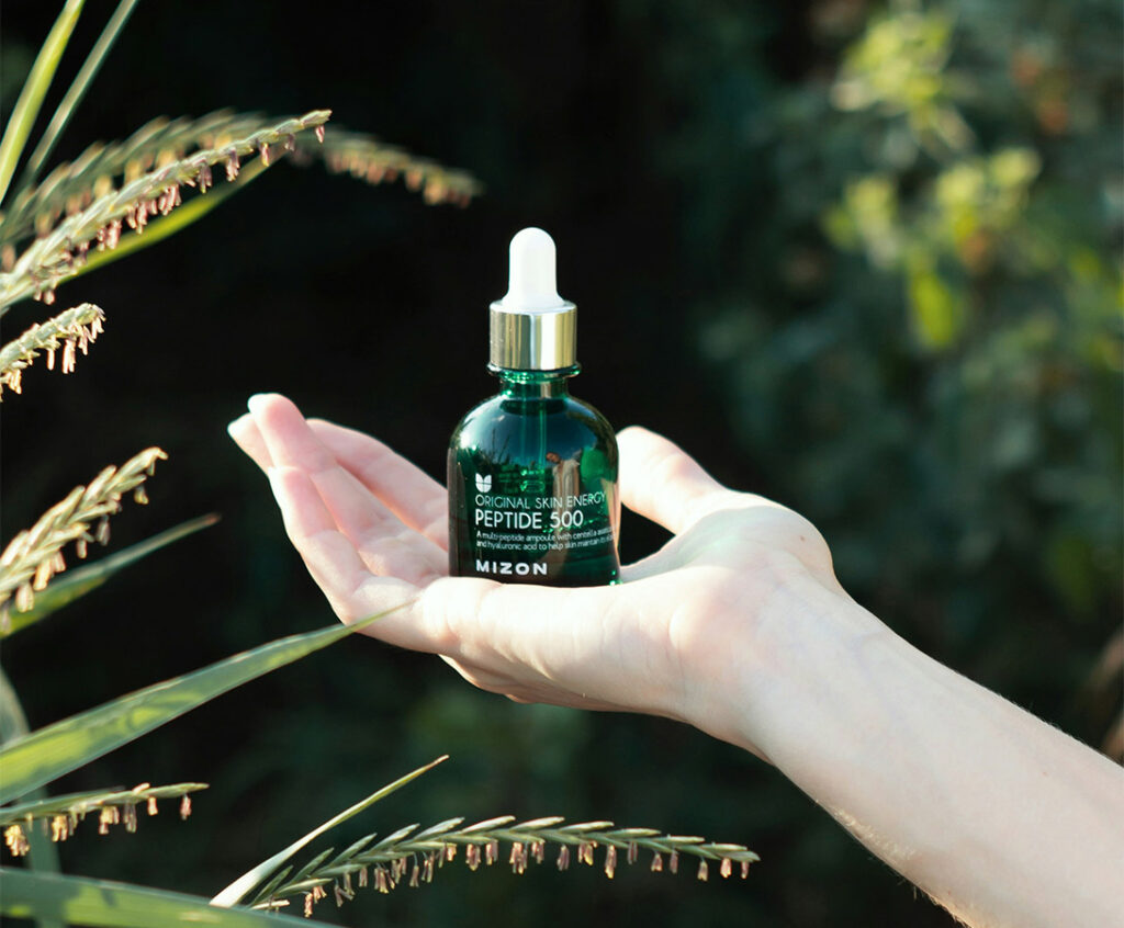 a green dropper bottle made of recyclable glass